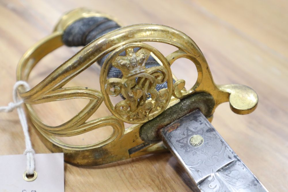 A Victorian officers sword, shagreen grip and 81cm curved, etched, single-edged blade, gilt metal scabbard, inscribed and personalised